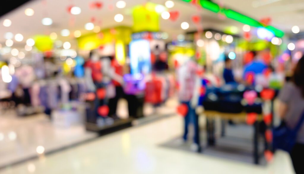 Defocused Clothing Store Front Entrance Displaying Woman's Fashi